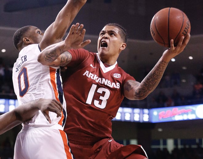 Arkansas forward Dustin Thomas goes up for a shot against Horace Spencer on Saturday