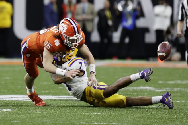 Trevor Lawrence fumbles after a hit by Grant Delpit.