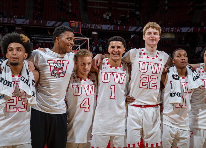 Wisconsin players sing "Varsity" with the Badgers student section following their victory over Marquette.