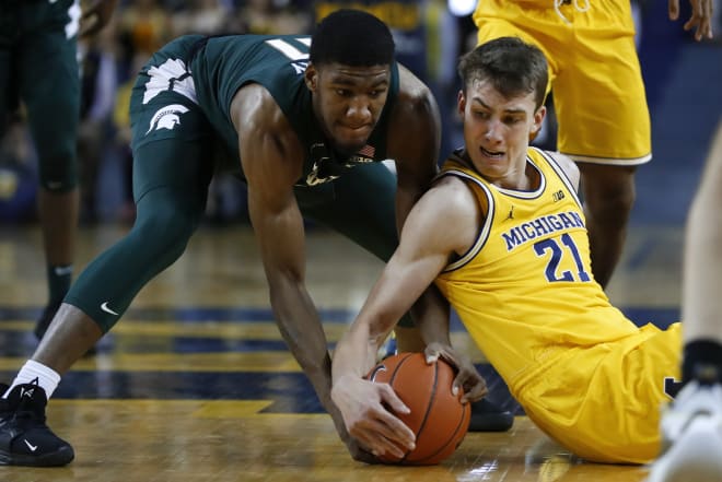 Michigan Wolverines basketball sophomore wing Franz Wagner battles against MSU junior guard Aaron Henry in last year's U-M win at Crisler Center.