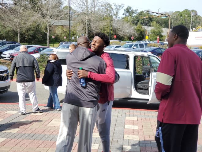 Wide receiver Darion Williamson shares a hug with recruiting coordinator David Johnson.