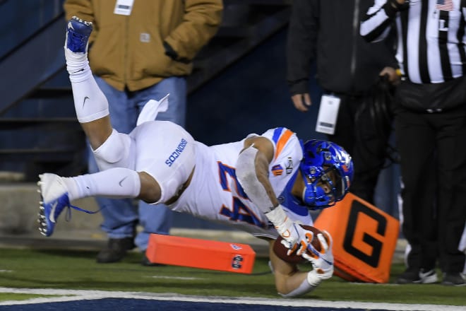 Boise State running back George Holani (24) dives into the end zone for a 5-yard touchdown against Utah State during the first half of an NCAA college football game Saturday, Nov. 23, 2019, in Logan, Utah.
