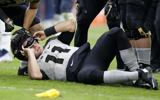 Blough lays on the turf after appearing to dislocate his right ankle early in the fourth quarter of Purdue's win. 