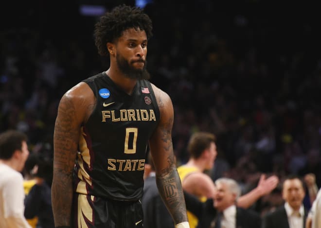 A dejected senior forward Phil Cofer walks off the court following FSU's 58-54 loss in the Elite Eight.