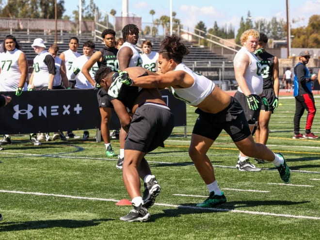 New Arizona commit Rhino Tapaatoutai (right) earned an offensive line MVP award at last month's Under Armour camp in California.