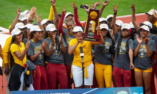 Caryl Smith Gilbert celebrates with her former team at South Cal after winning the national title.