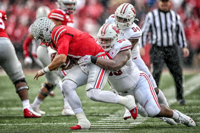 Wisconsin nose tackle Keeanu Benton sacks Ohio State quarterback Justin Fields on Oct. 26