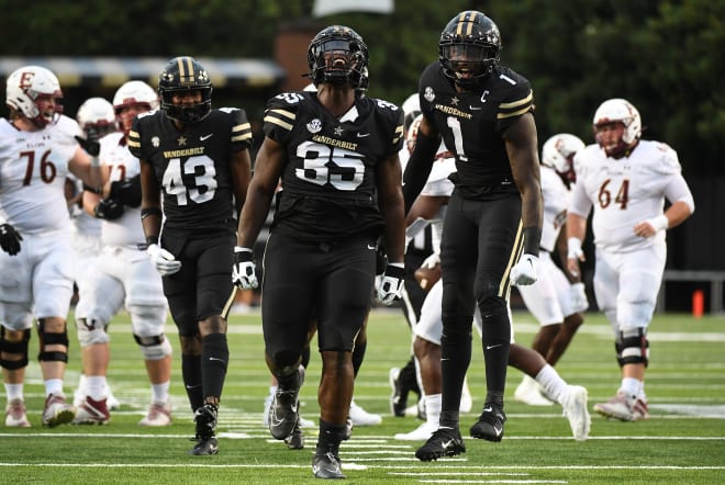 Sep 3, 2022; Nashville, Tennessee, USA; Vanderbilt Commodores defensive lineman Malik Langham (35) celebrates with linebacker De'Rickey Wright (43) and defensive lineman Elijah McAllister (1) after a stop during the first half against the Elon Phoenix at FirstBank Stadium. Mandatory Credit: Christopher Hanewinckel-USA TODAY Sports