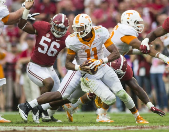 Tennessee quarterback Joshua Dobbs (11) scrambles under pressure from Alabama linebacker Tim Williams (56) and defensive lineman Da’Shawn Hand (9) during the Tennessee-Alabama game on Saturday, Oct. 24, 2015, in Tuscaloosa, Ala.