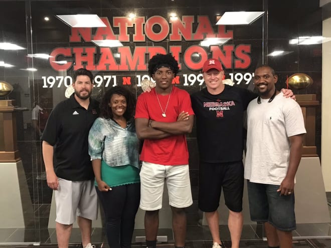 Travion Ford and his parents with  Husker coaches.