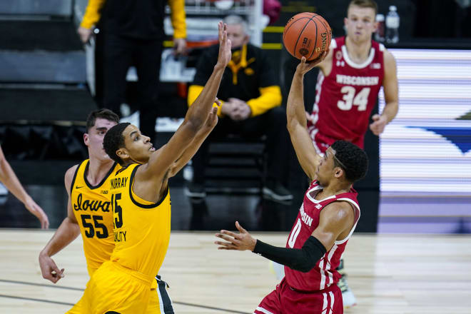 Wisconsin guard D'Mitrik Trice (0) shoots over Iowa forward Keegan Murray (15) in the first half.