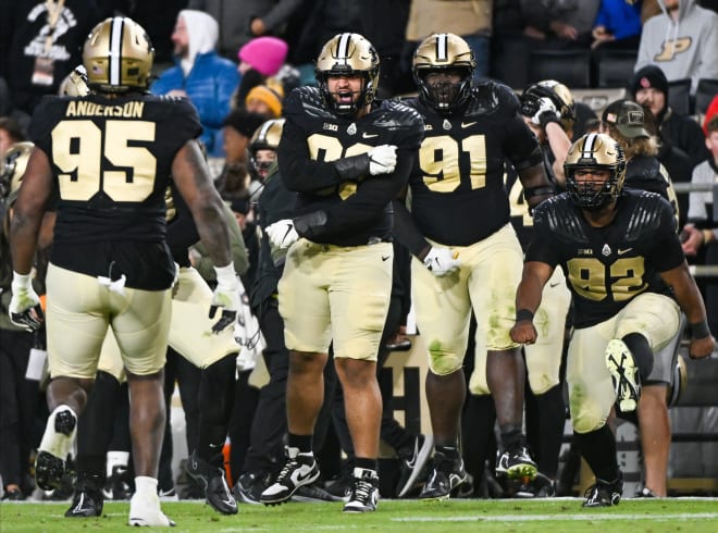 Nov 11, 2023; West Lafayette, Indiana, USA; Purdue Boilermakers defensive linemen Isaiah Nichols (93), Cole Brevard (91) and Mo Omonode (92) celebrate with defensive lineman Joe Anderson (95) after a defensive stop against the Minnesota Golden Gophers during the second half at Ross-Ade Stadium. Mandatory Credit: Robert Goddin-USA TODAY Sports