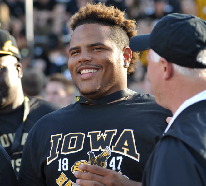 Defensive tackle Noah Shannon talks with Iowa assistant coach Reese Morgan.