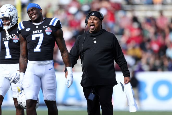 Duke interim coach Trooper Taylor reacts with running back Jordan Waters (No. 7) during the Birmingham Bowl. 