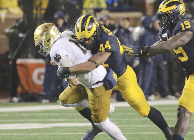 Michigan Wolverines redshirt freshman linebacker Cam McGrone with a big hit on Notre Dame QB Ian Book.