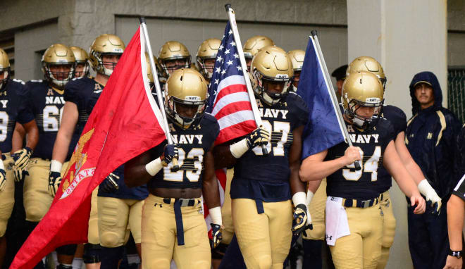 Members of the U.S. Air Force Academy and U.S. Naval Academy football teams  watch as Army