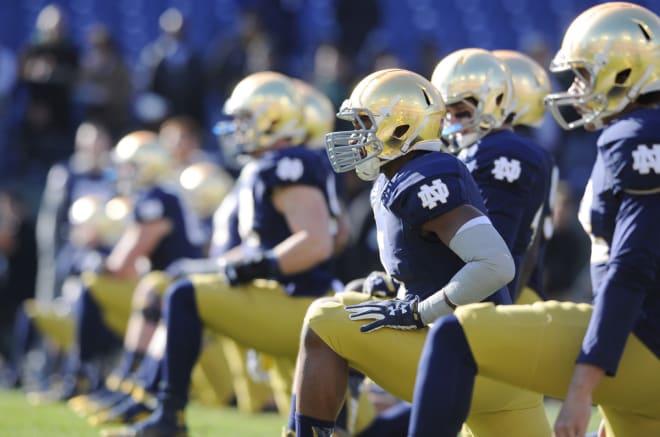 Notre Dame football players stretching before a game. 