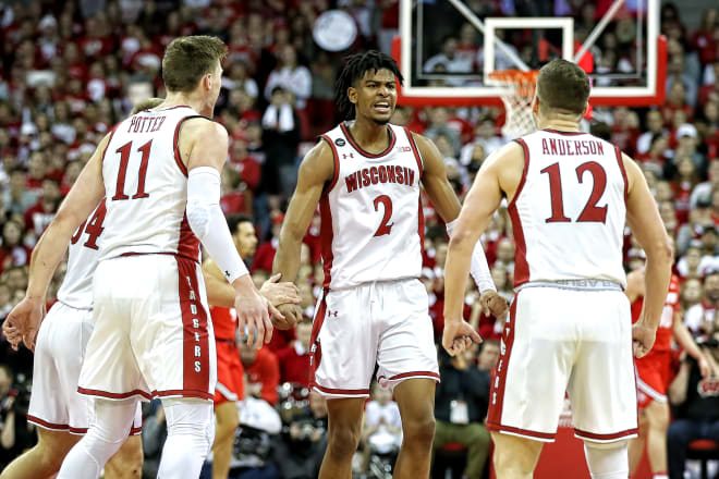 Aleem Ford (2) celebrates with teammates Micah Potter (11) and Trevor Anderson (12) during Wisconsin's 70-57 win over Ohio State