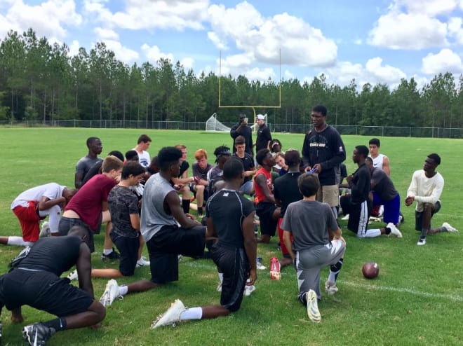 Former FSU star Kez McCorvey talks Friday with participants at his first Nole Legends wide receiver camp at Tallahassee's St. John Paul II Catholic School.