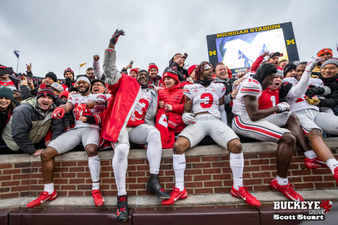 Ohio State players celebrate with Buckeye fans at Michigan Stadium.