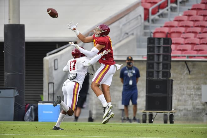Redshirt freshman tight end Jude Wolfe goes up to make a play over grad transfer safety Micah Croom in USC's second preseason scrimmage Saturday morning in the Coliseum.