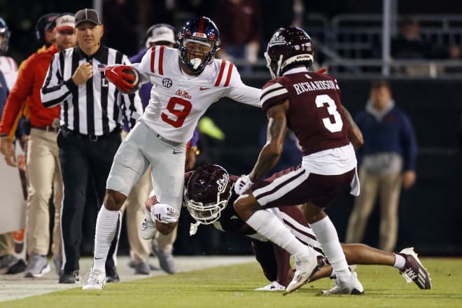 Ole Miss Rebels wide receiver Tre Harris (9) runs after a catch as Mississippi State Bulldogs defensive backs Marcus Banks (1) and Decamerion Richardson (3) make the tackle during the first half at Davis Wade Stadium at Scott Field. Mandatory Credit: Petre Thomas-USA TODAY Sports