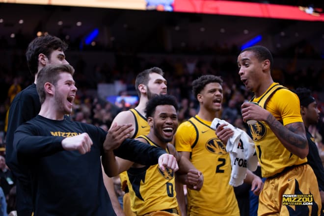Sophomore guard Xavier Pinson, right, screams with the rest of the Missouri bench after teammate Jeremiah Tilmon dunked overtop Illinois during the annual Braggin' Rights game on Saturday, Dec. 21, 2019, at the Enterprise Center in St. Louis, Mo. Missouri topped Illinois 63-56 to win the title for the second year in a row.