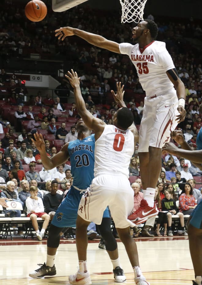 Alabama forward Donta Hall leaps high to block a shot by Coastal Carolina forward Demario Beck during the opening night game with the Chanticleers in Coleman Coliseum on Nov. 11. Staff Photo/Gary Cosby Jr. 