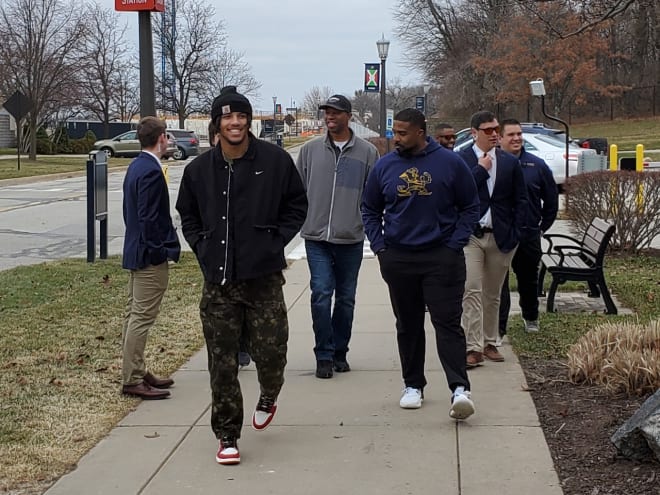 2024 four-star defensive end Jacob Smith (front left) and defensive line coach Al Washington (front right) walk together during Smith's visit. 