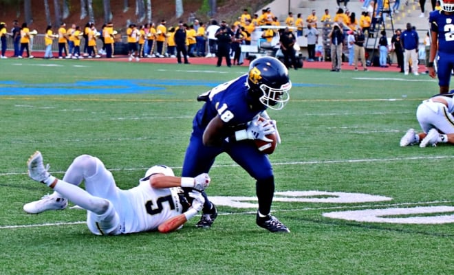 Southwest DeKalb's Sam Turner (18) tries to break away from a St. Pius X defender after making a catch in the first half of Thursday's region contest at Godfrey Stadium.