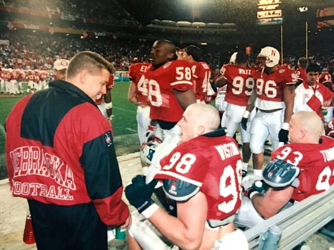 Ellis talks with Nebraska defensive linemen Grant Wistrom and Jared Tomich during the 1996 Fiesta Bowl against Florida.