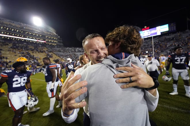 Bryan Harsin hugs his son, Dave, after Auburn defeated LSU. 
