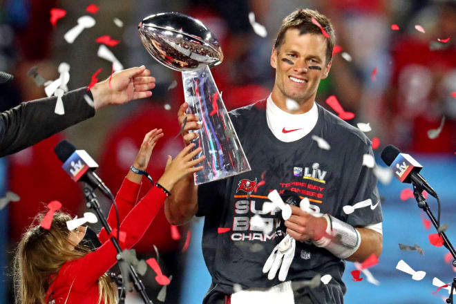 Tom Brady hoists the Super Bowl championship trophy for the seventh time in his unmatched career.