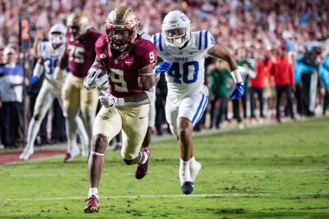 FSU's Lawrence Toafili, left, scores with Duke defensive end Ryan Smith trailing on Saturday night. 