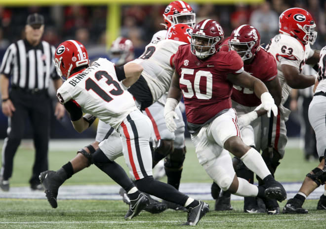 Alabama defensive lineman Tim Smith (50) pressures Georgia quarterback Stetson Bennett (13) during the SEC championship game at Mercedes-Benz Stadium.  Photo | Gary Cosby Jr.