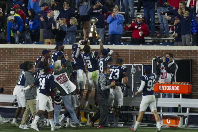 Ole Miss quarterback Matt Corral (2) and his teammates celebrate Saturday's Egg Bowl win over Mississippi State.