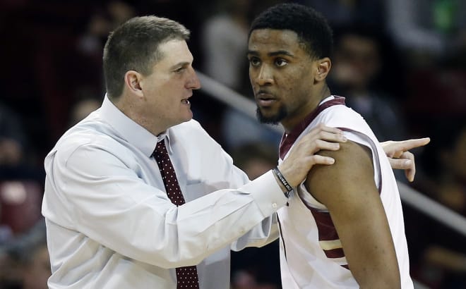 Coach Jim Christian talks with senior Garland Owens (AP PHOTO)