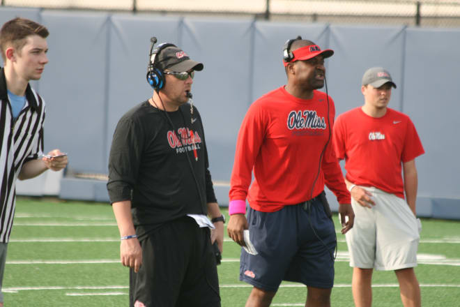 Hugh Freeze and Derrick Nix watch the scrimmage portion of Tuesday's practice.