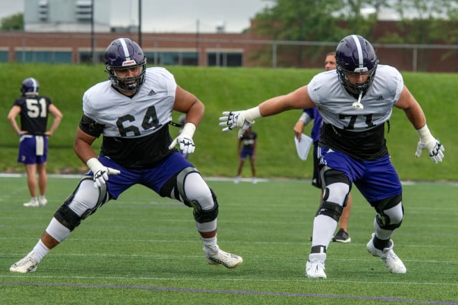 Luke Newman (No. 71) warms up with  Eric Schon (No. 64) while at Holy Cross in August of 2023. 