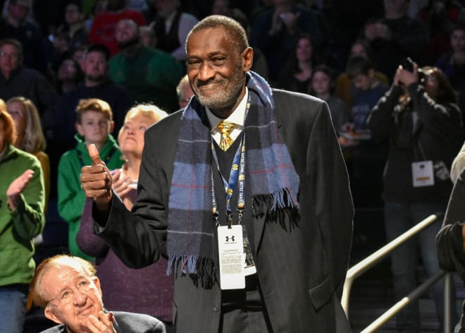 Whitmore saluted an appreciative Notre Dame audience upon his induction into the Ring of Honor. (High school coach Morgan Wootten is to his right.)