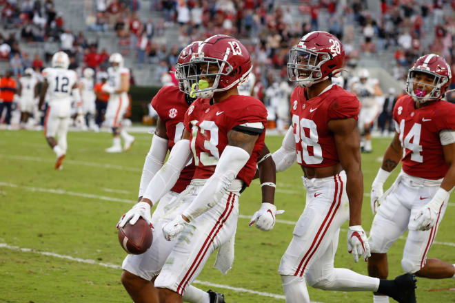 Alabama Crimson Tide defensive backs, Malachi Moore (13), Josh Jobe (28) and Brian Branch (14) celebrate following a play during last year's Iron Bowl win over Auburn. Photo | Getty Images 