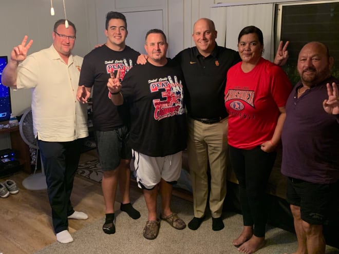 USC assistant coach Tim Drevno (far left) and head coach Clay Helton (middle) visited 3-star OL commit Gino Quinones (second from left) on Monday in Hawaii.