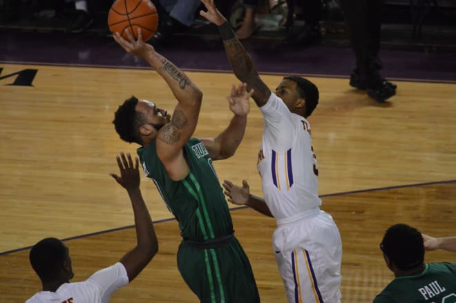 Tulane's Louis Dabney shoots over ECU's Lance Tejada in the Green Wave's 100-92  triple OT victory.