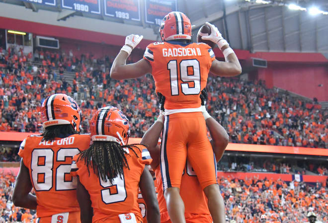 Sep 17, 2022; Syracuse, New York, USA; Syracuse Orange wide receiver Oronde Gadsden II (19) is hoisted by teammates after catching a winning touchdown against the Purdue Boilermakers late in the fourth quarter at JMA Wireless Dome. Mandatory Credit: Mark Konezny-USA TODAY Sports