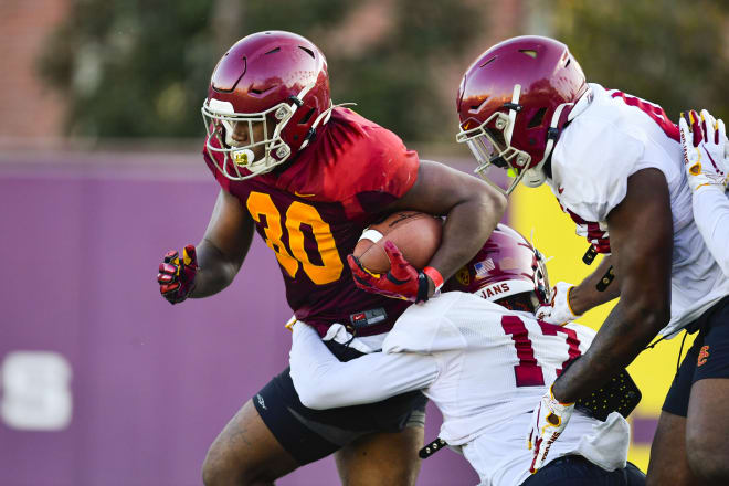 Markese Stepp takes on some contact Monday as USC moved to shells (shoulder pads and helmets).