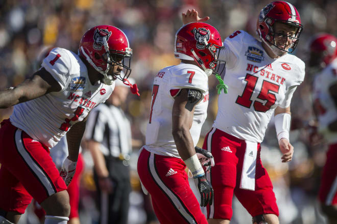 NC State’s Jaylen Samuels, far left, Nyheim Hines, middle, and Ryan Finley celebrated during the Wolfpack’s 52-31 victory over Arizona State last Friday in the Sun Bowl.