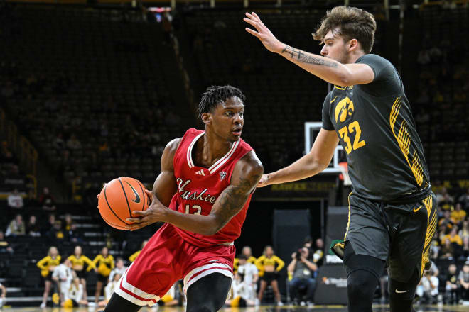 Northern Illinois Huskies forward Xavier Amos (13) goes to the basket against Iowa Hawkeyes forward Owen Freeman last December