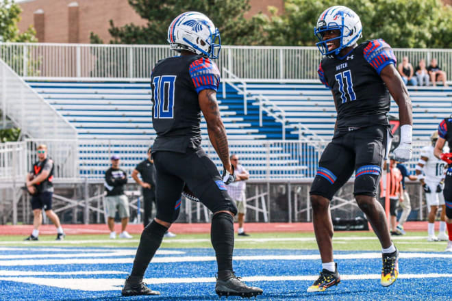 Malik Benson (#11) celebrating with a teammate