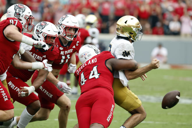 NC State's Brandon Cleveland strips the ball from Notre Dame QB Dam Hartman.