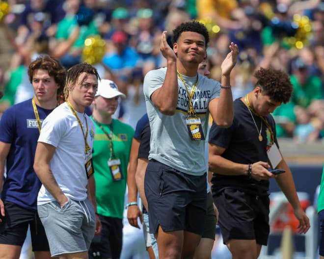 Notre Dame defensive end commitment Keon Keeley (clapping) and a group of Irish football recruits take in the Blue-Gold Game, Saturday at Notre Dame Stadium.